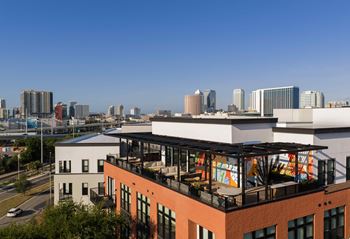 A cityscape with a building in the foreground and a clear blue sky